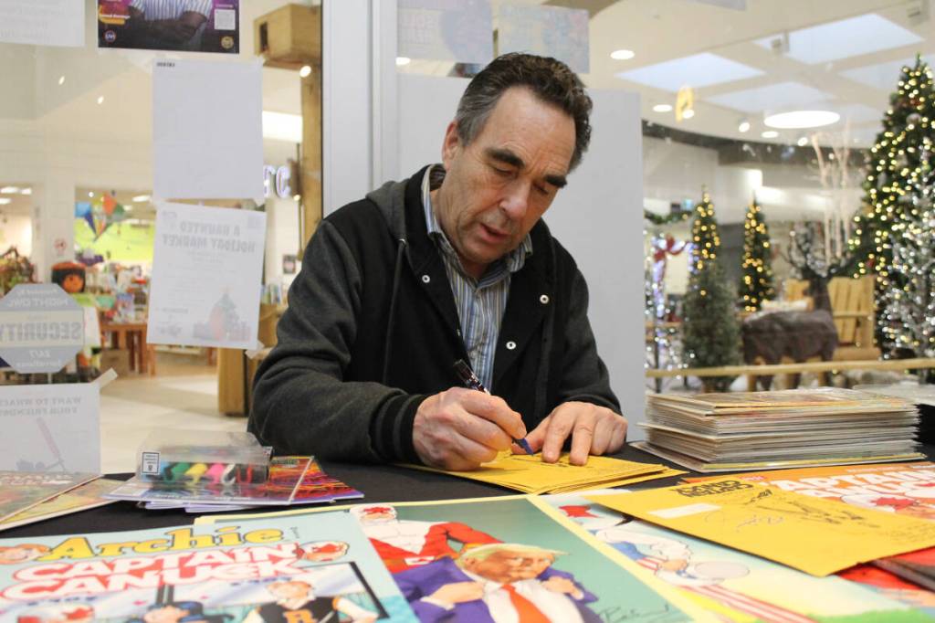Richard Comely, creator of Captain Canuck, signs autographs at Curious Comics on Wednesday, Nov. 26. (Jessica Durling/News Bulletin)